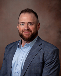 Matthew Pruitt, MBA, MLS (ASCP), Chief Operations and Compliance Officer smiling